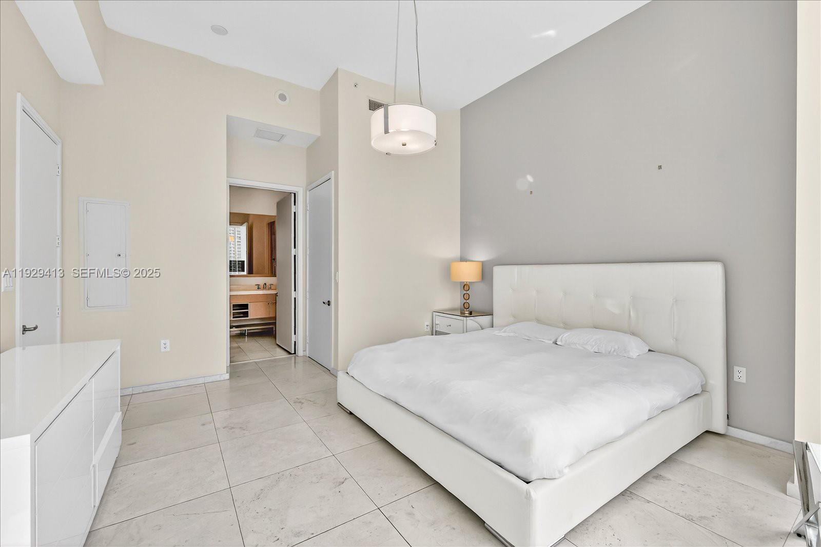 900 Brickell Key Boulevard, Unit 2605 Miami, FL 33131 - Photo 13 of 43 a bedroom with a bed and a view of bathroom