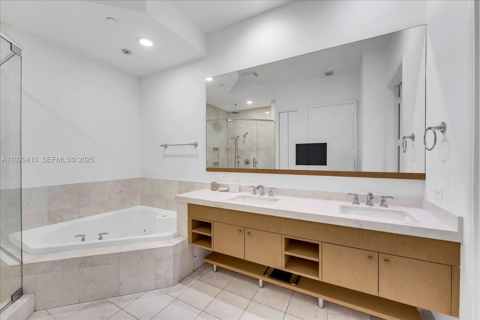 900 Brickell Key Boulevard, Unit 2605 Miami, FL 33131 - Photo 14 of 43 a bathroom with a tub sink double and mirror