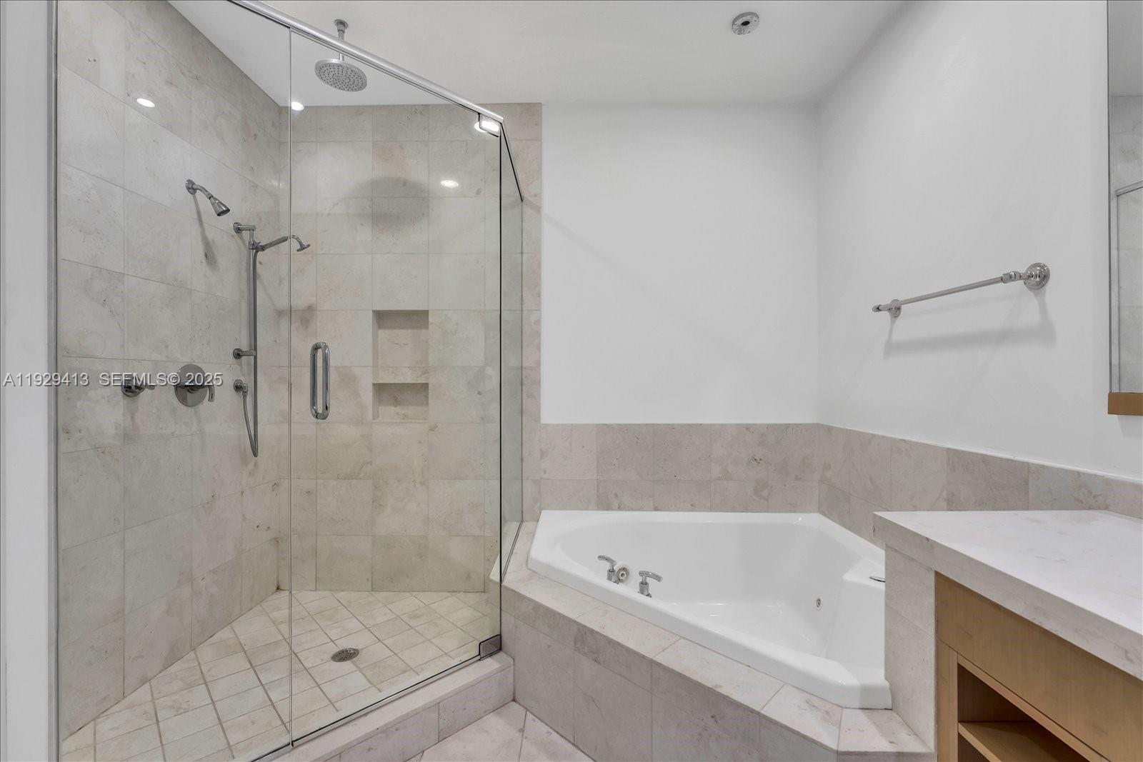 900 Brickell Key Boulevard, Unit 2605 Miami, FL 33131 - Photo 15 of 43 a bathroom with a bathtub and a shower