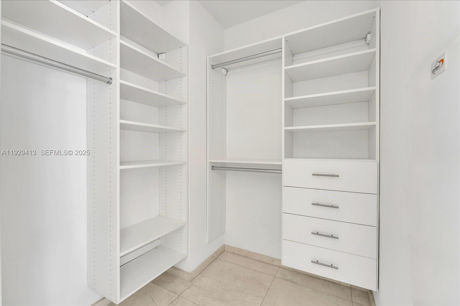 900 Brickell Key Boulevard, Unit 2605 Miami, FL 33131 - Photo 18 of 43 a view of walk in closet with empty racks