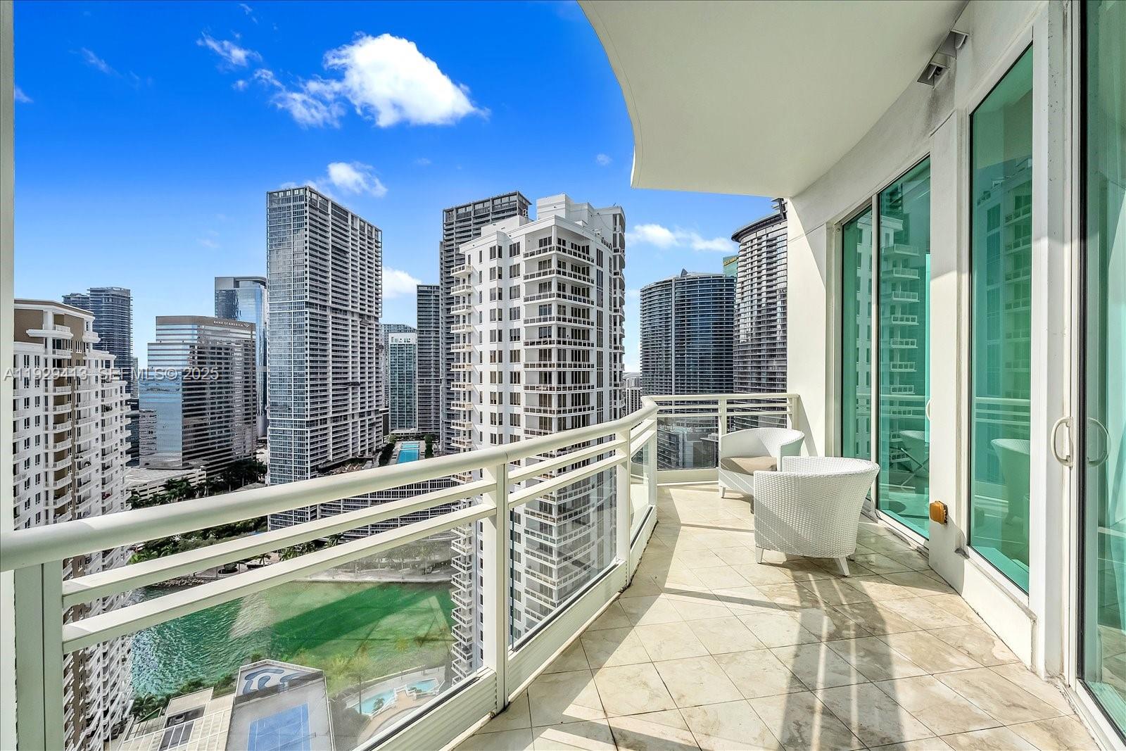 900 Brickell Key Boulevard, Unit 2605 Miami, FL 33131 - Photo 20 of 43 a balcony with chairs and city view