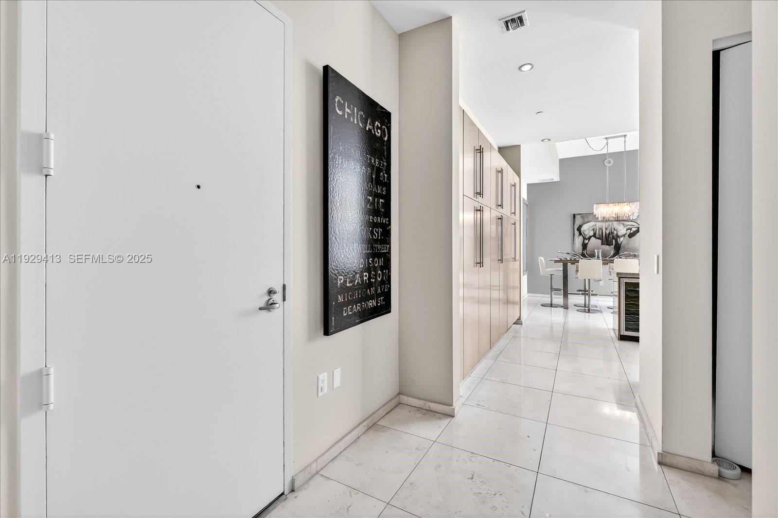 900 Brickell Key Boulevard, Unit 2605 Miami, FL 33131 - Photo 26 of 43 a view of a hallway with a furniture and a refrigerator