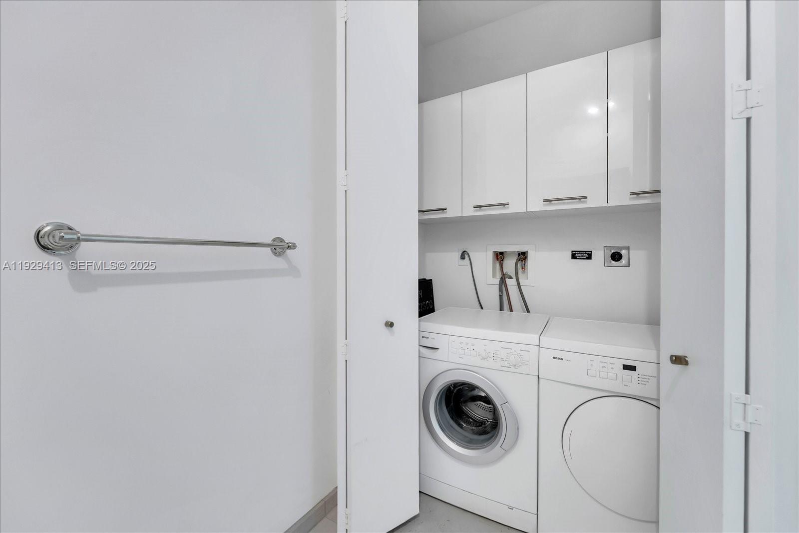 900 Brickell Key Boulevard, Unit 2605 Miami, FL 33131 - Photo 28 of 43 a utility room with dryer and washer