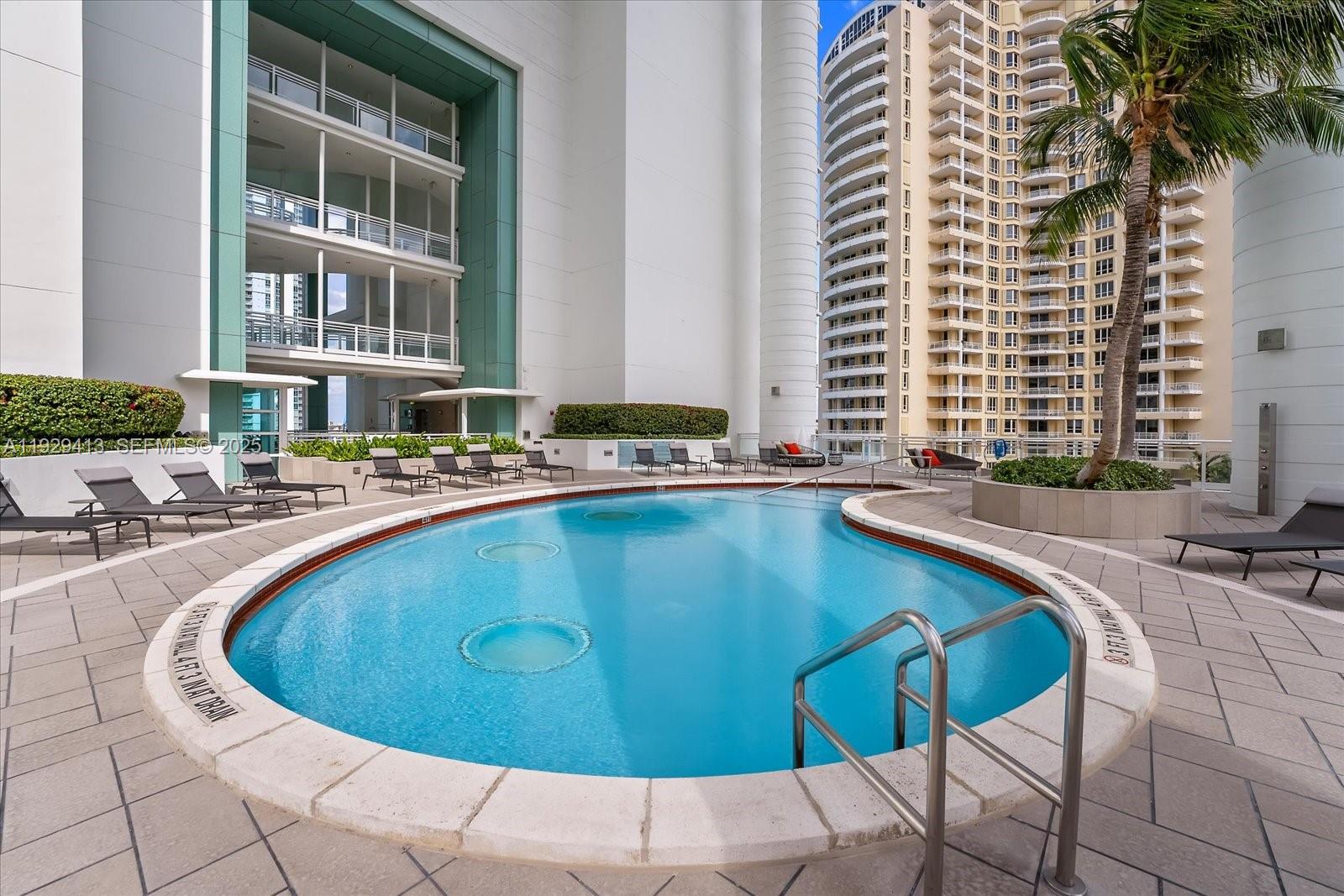 900 Brickell Key Boulevard, Unit 2605 Miami, FL 33131 - Photo 35 of 43 a view of a swimming pool with outdoor seating
