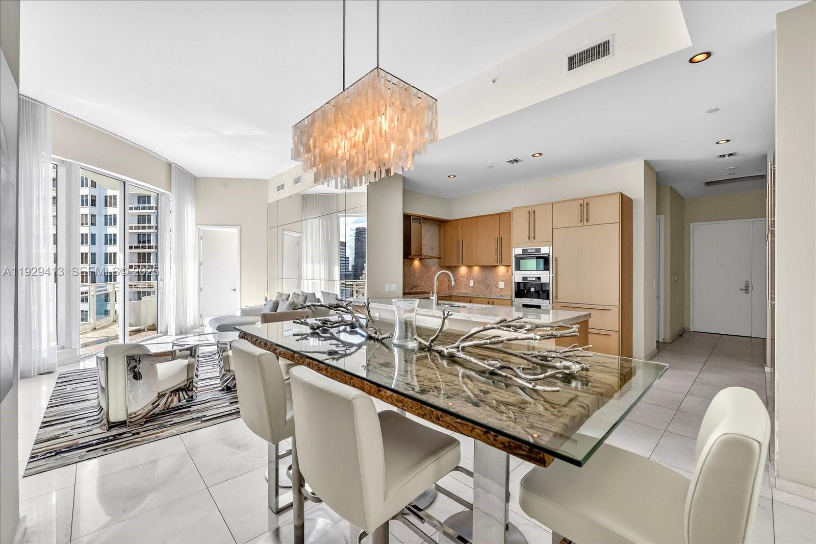 900 Brickell Key Boulevard, Unit 2605 Miami, FL 33131 - Photo 4 of 43 a view of a kitchen area kitchen island furniture and a chandelier