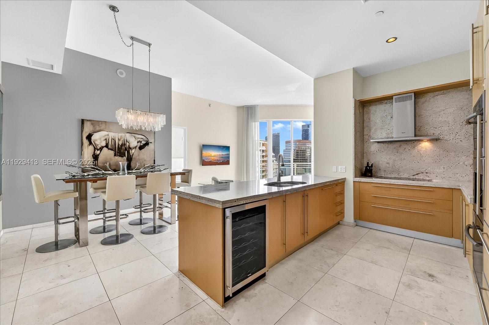 900 Brickell Key Boulevard, Unit 2605 Miami, FL 33131 - Photo 8 of 43 a large kitchen with kitchen island cabinets and counter space