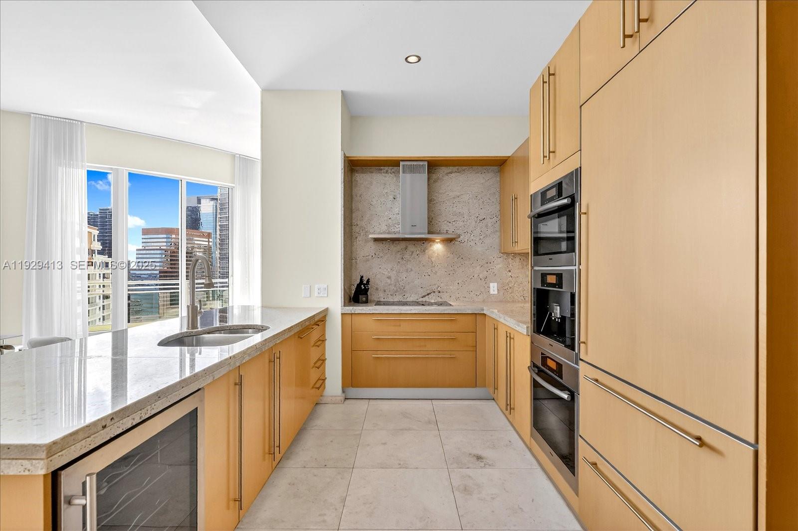 900 Brickell Key Boulevard, Unit 2605 Miami, FL 33131 - Photo 9 of 43 a kitchen with stainless steel appliances a refrigerator and a sink