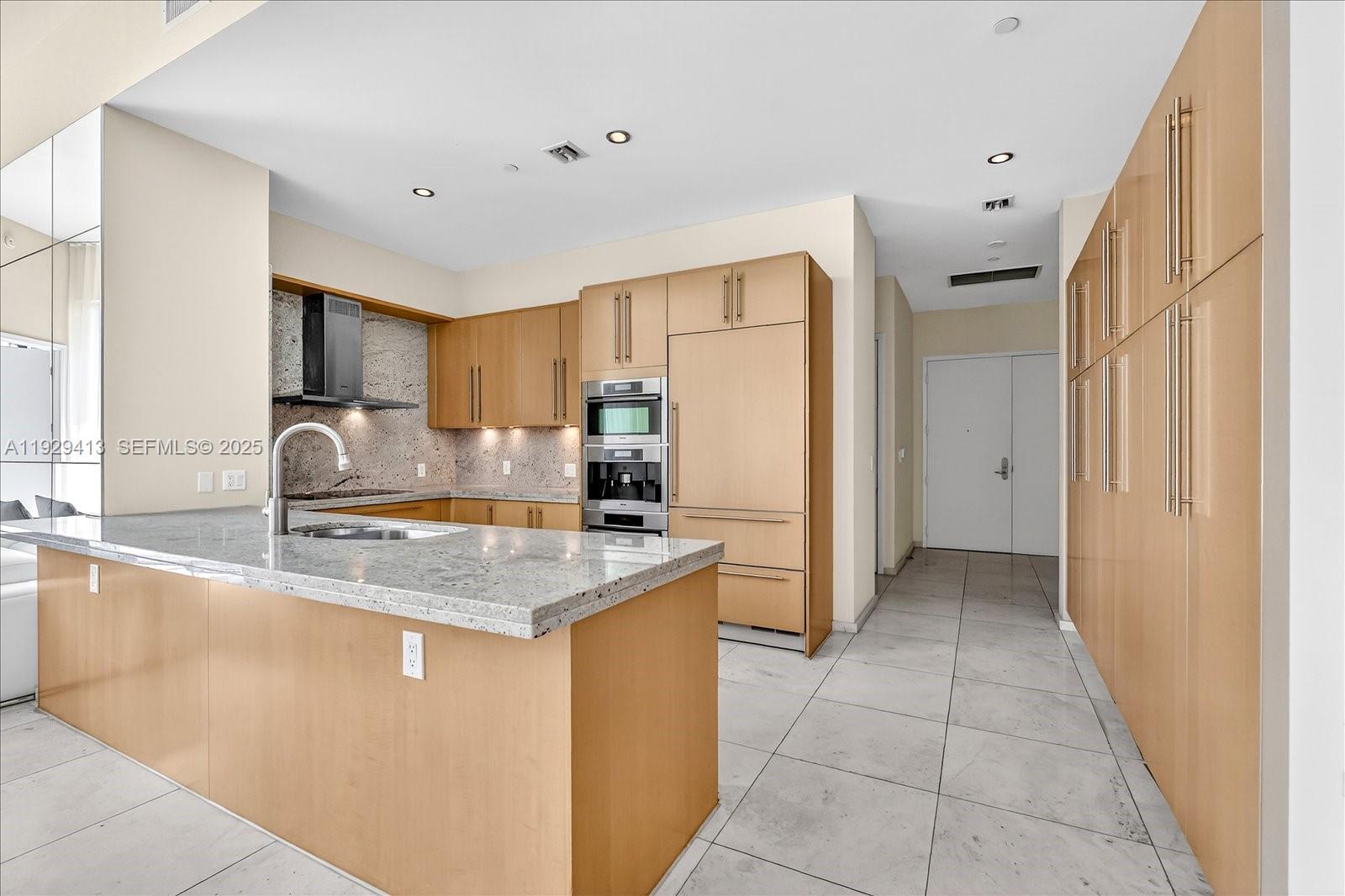 900 Brickell Key Boulevard, Unit 2605 Miami, FL 33131 - Photo 10 of 43 a kitchen with stainless steel appliances granite countertop a sink stove and refrigerator