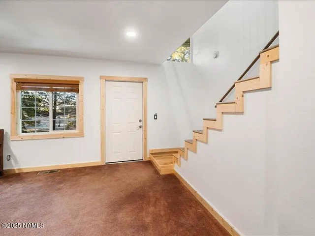 a view of a lake with a table and chairs