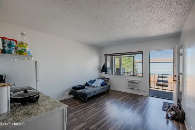 a view of a dining room with furniture and a window