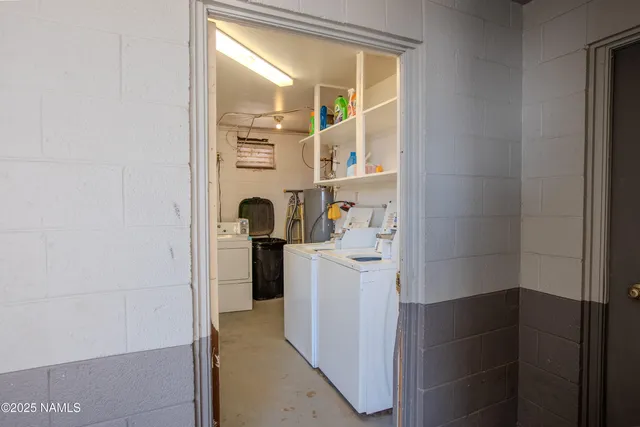 a view of a workspace with furniture and a flat screen tv