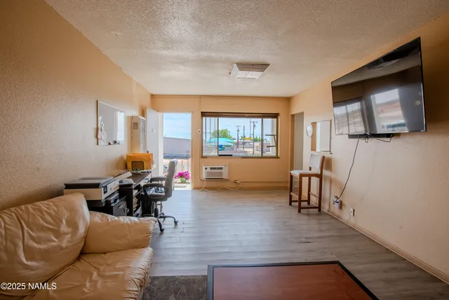 a kitchen with cabinets appliances and wooden floor