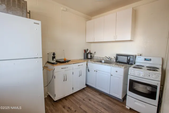 a bedroom with a bed and large window