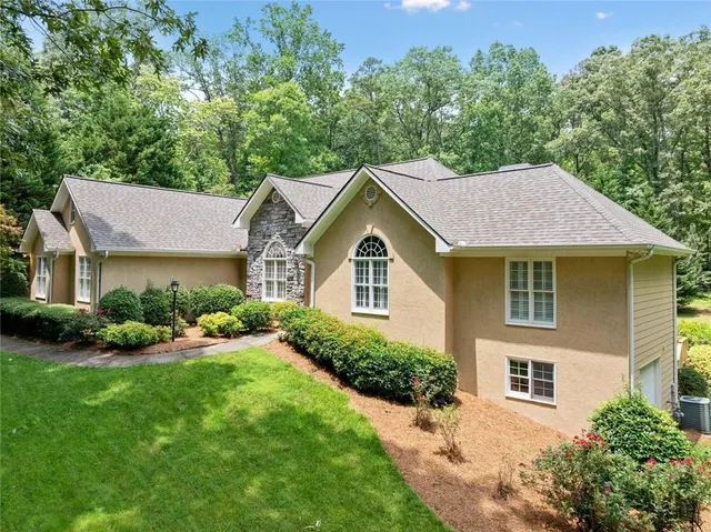 a view of green field with trees in the background