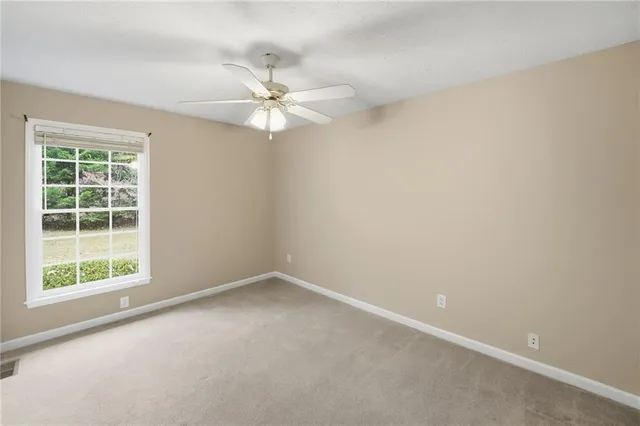 a bathroom with a granite countertop double vanity sink and a mirror