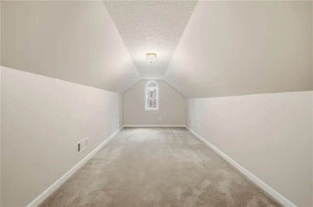 a view of an empty room with a staircase