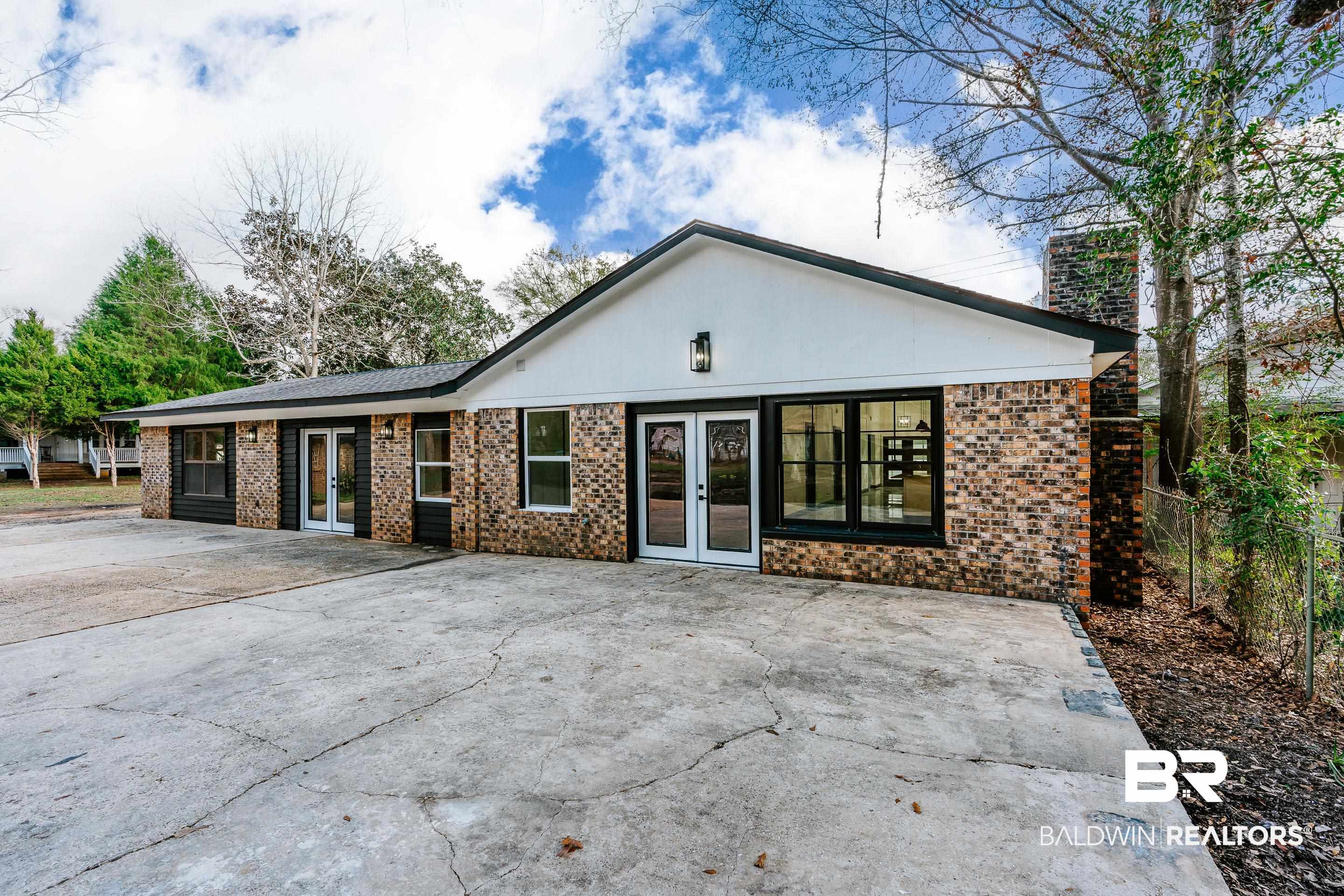 1190 Military Road Mount Vernon, AL 36560 - Photo 39 of 47 Rear view of property with french doors, brick siding, and a patio