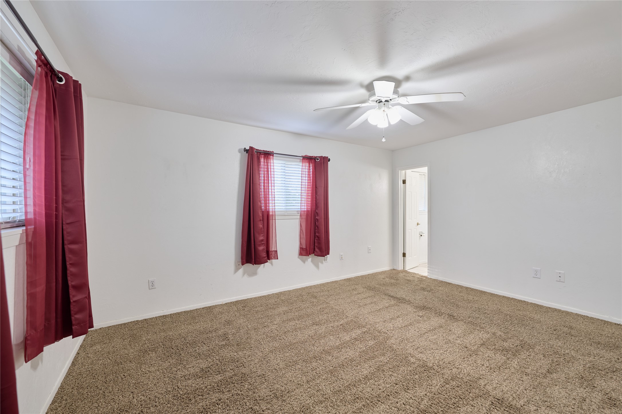 21807 Greengate Drive Spring, TX 77388 - Photo 23 of 44 a view of a bedroom with a ceiling fan and a window