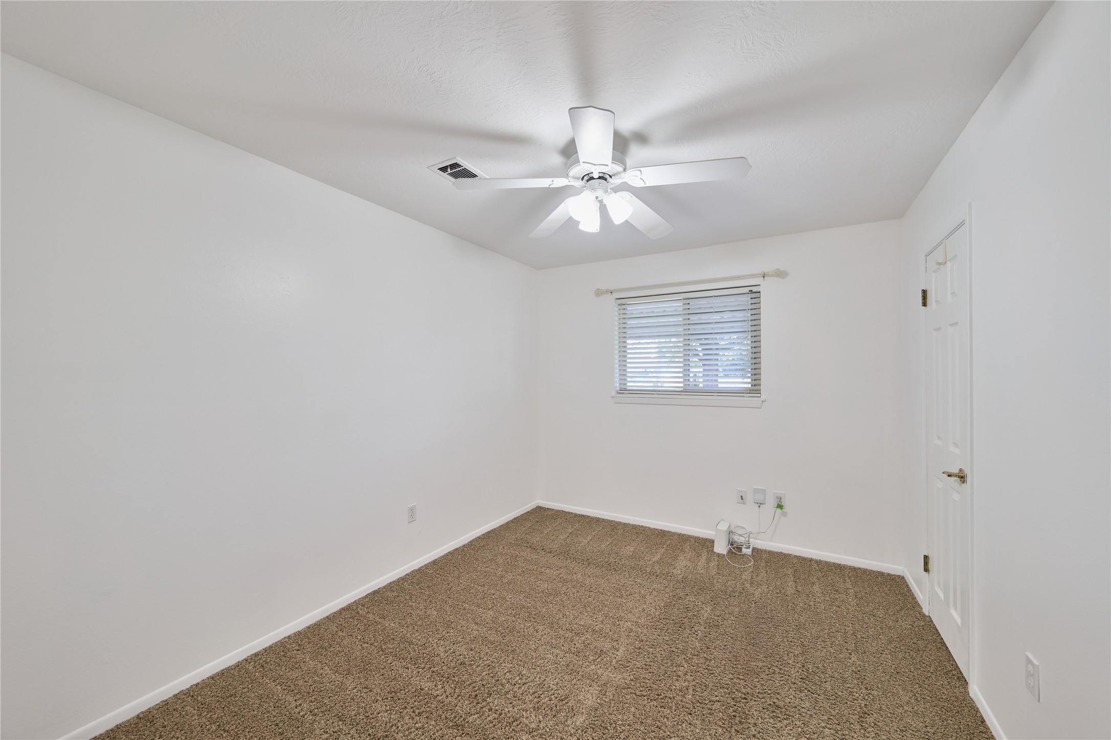 21807 Greengate Drive Spring, TX 77388 - Photo 26 of 44 an empty room with a window and a ceiling fan