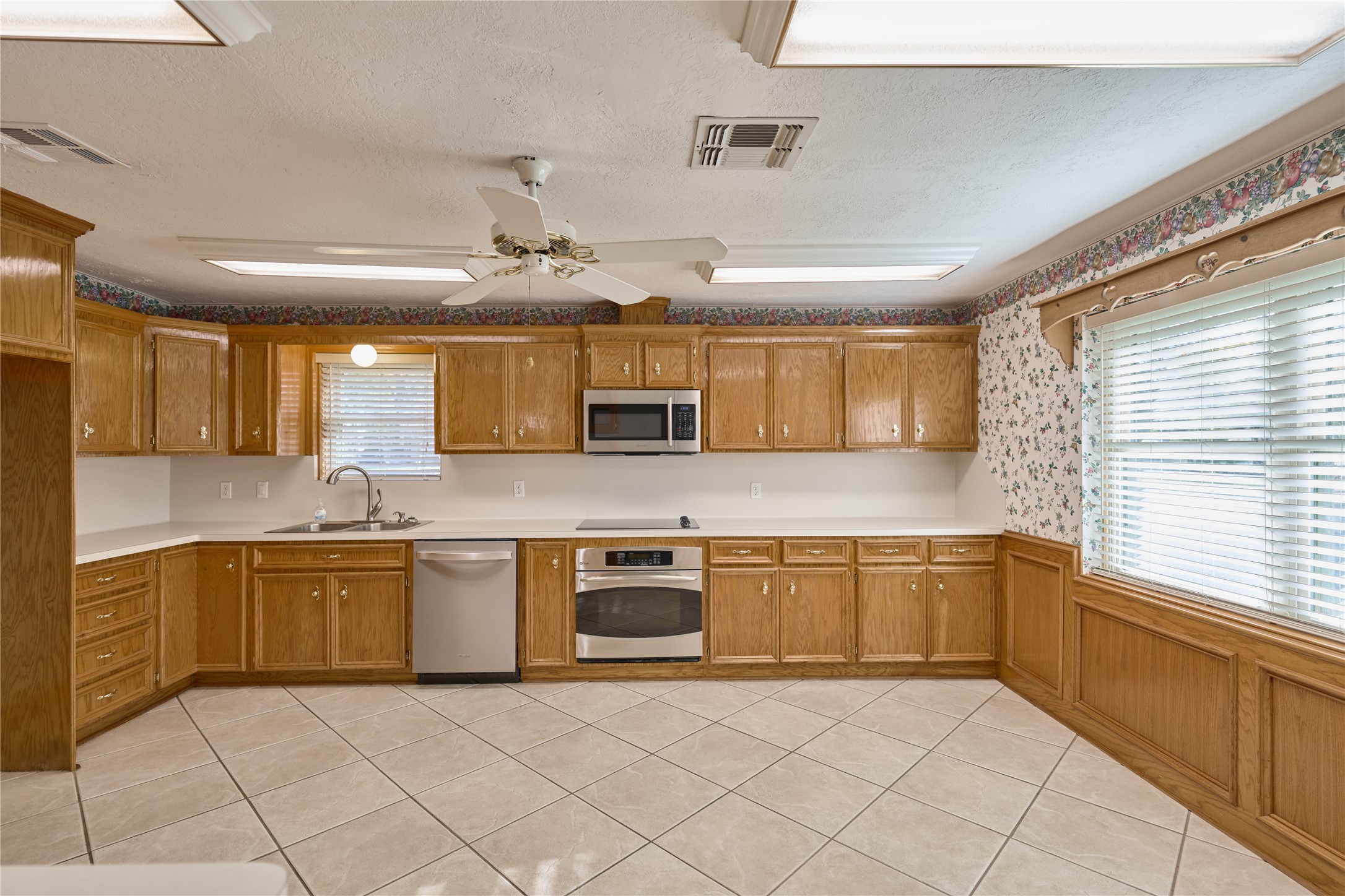 21807 Greengate Drive Spring, TX 77388 - Photo 34 of 44 a large kitchen with stainless steel appliances granite countertop a stove and a sink
