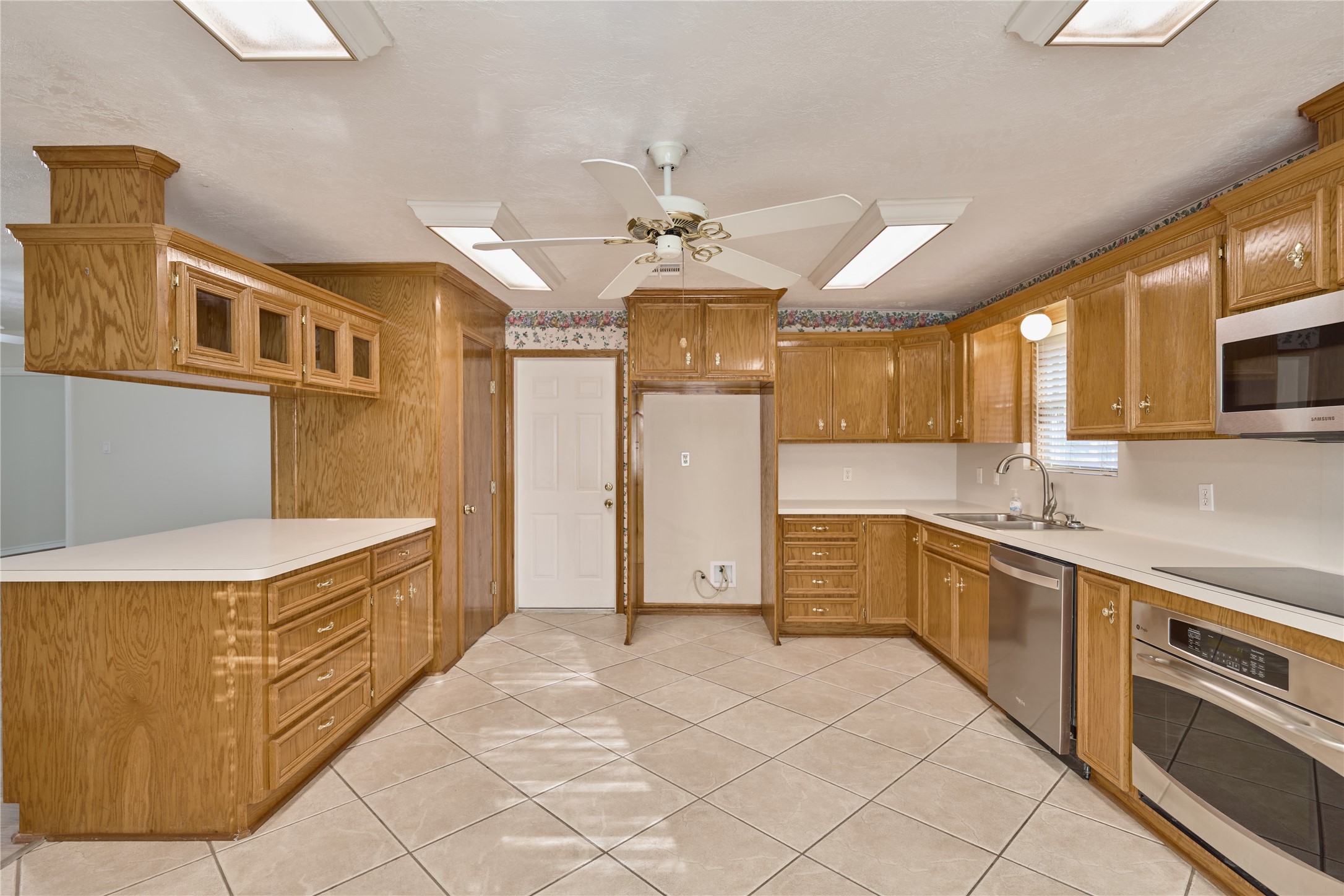 21807 Greengate Drive Spring, TX 77388 - Photo 35 of 44 a large kitchen with stainless steel appliances granite countertop a stove a sink and a refrigerator