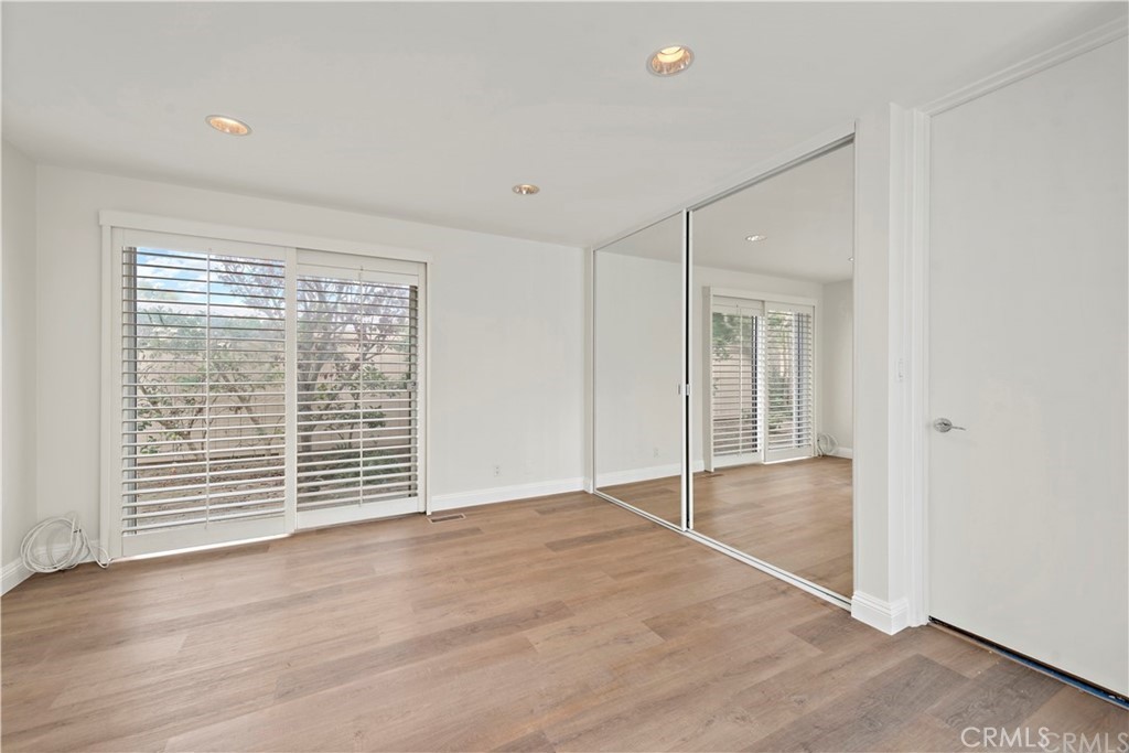 147 Monarch Bay Drive Dana Point, CA 92629 - Photo 15 of 23 an empty room with wooden floor and windows
