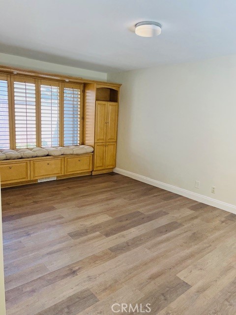 147 Monarch Bay Drive Dana Point, CA 92629 - Photo 16 of 23 a view of an empty room with wooden floor and a window