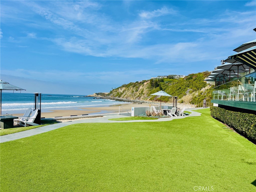 147 Monarch Bay Drive Dana Point, CA 92629 - Photo 22 of 23 a view of a large pool with lawn chairs and large trees