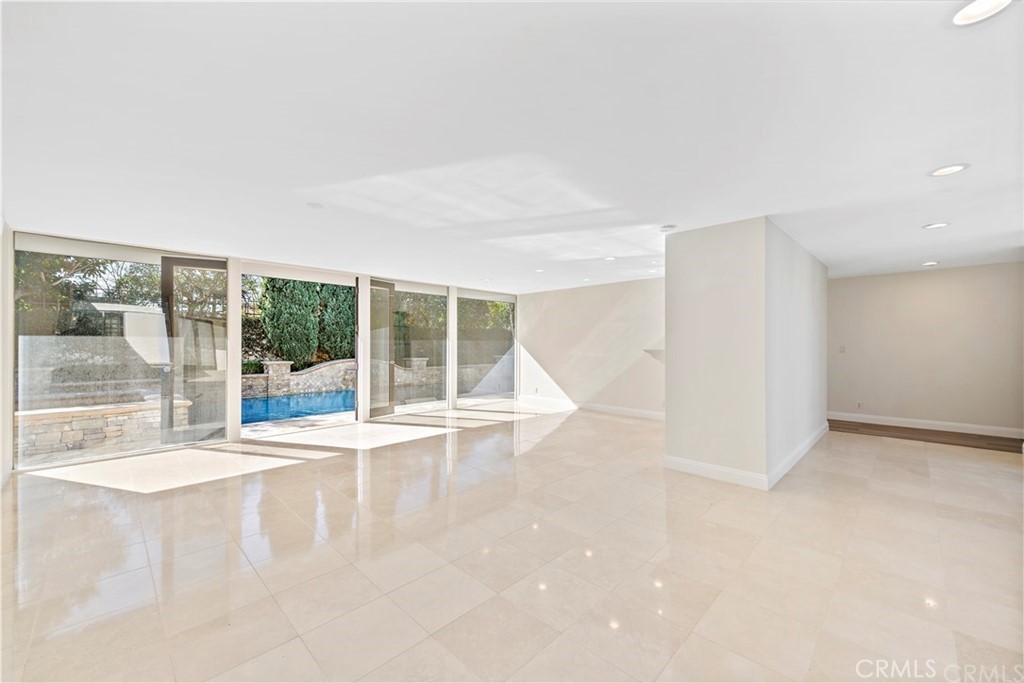 147 Monarch Bay Drive Dana Point, CA 92629 - Photo 10 of 23 an empty room with wooden floor and windows