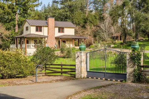a view of a house with a garden and pathway