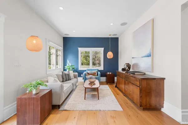 a living room with furniture potted plant and windows