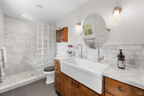 a bathroom with a sink double vanity and toilet