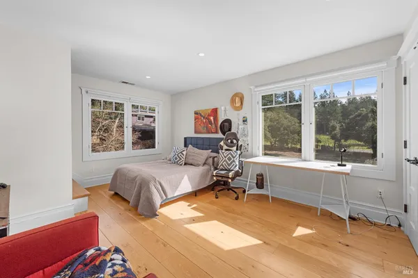 a bed room with a bed and a chair