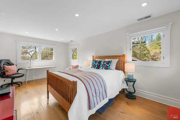 a bedroom with bed and window