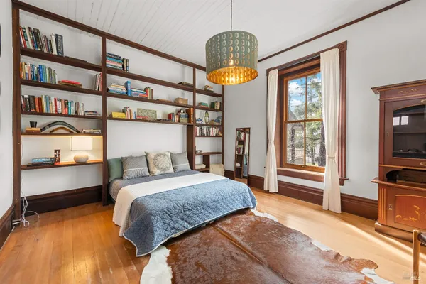 a bedroom with a bed and a large window