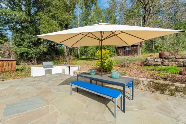 a view of table and chairs under an umbrella