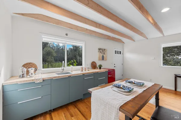 a kitchen with a sink cabinets and wooden floor