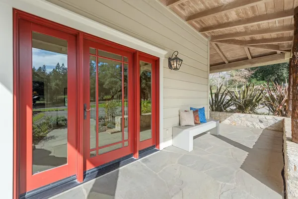 a view of a porch with a floor to ceiling window