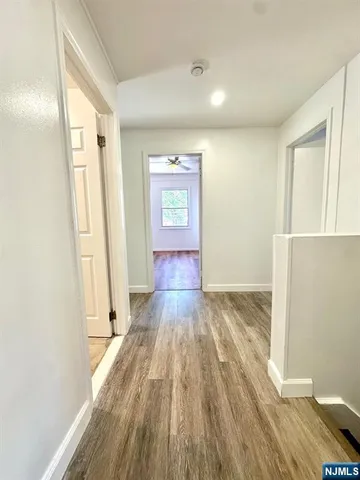 a view of hallway with wooden floor