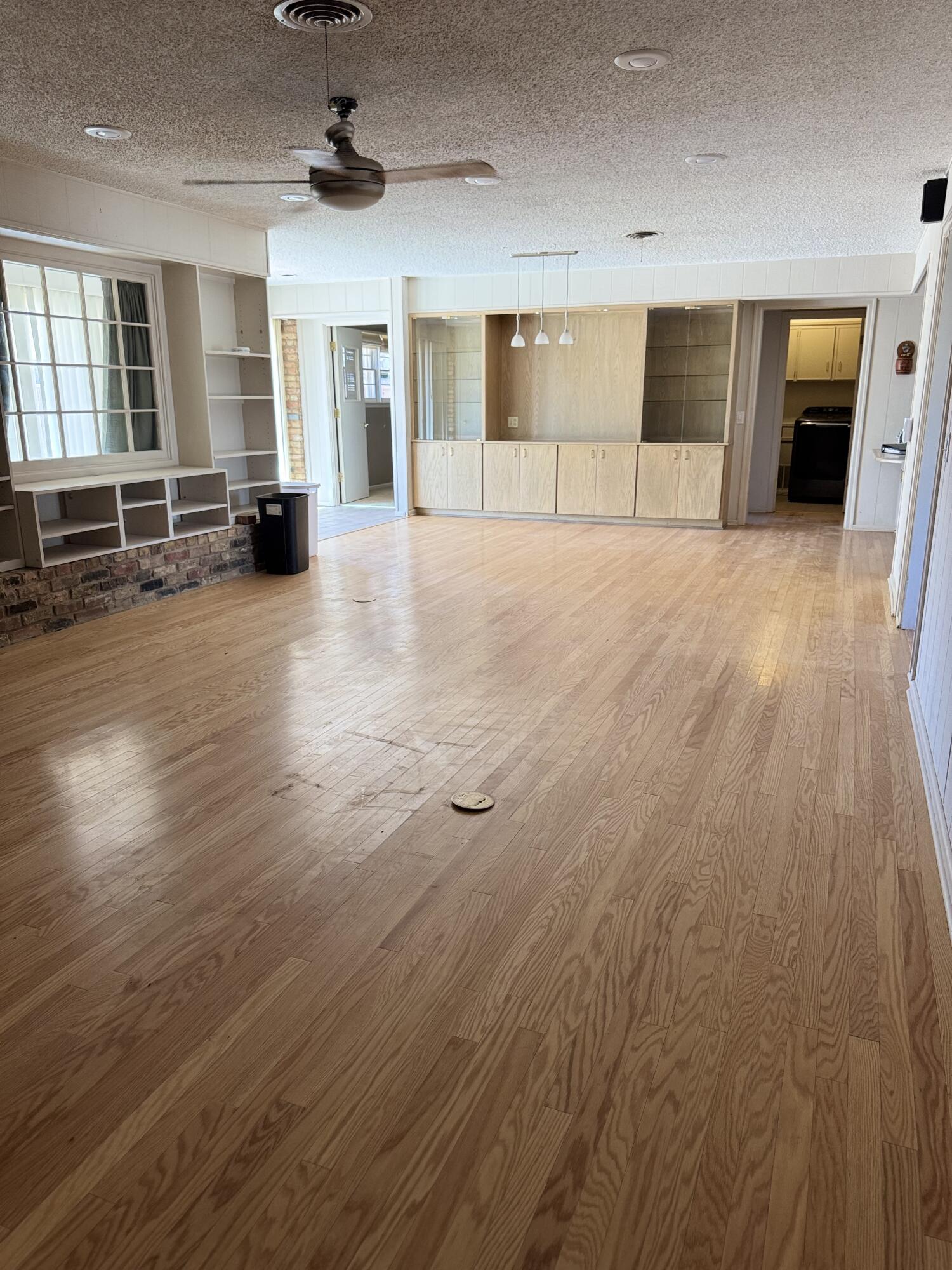 2115 62nd Street Lubbock, TX 79412 - Photo 12 of 15 an empty room with wooden floor and windows