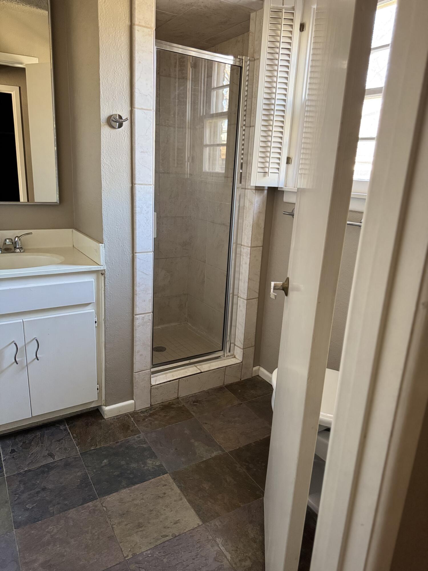2115 62nd Street Lubbock, TX 79412 - Photo 3 of 15 a view of front door with a sink and a mirror