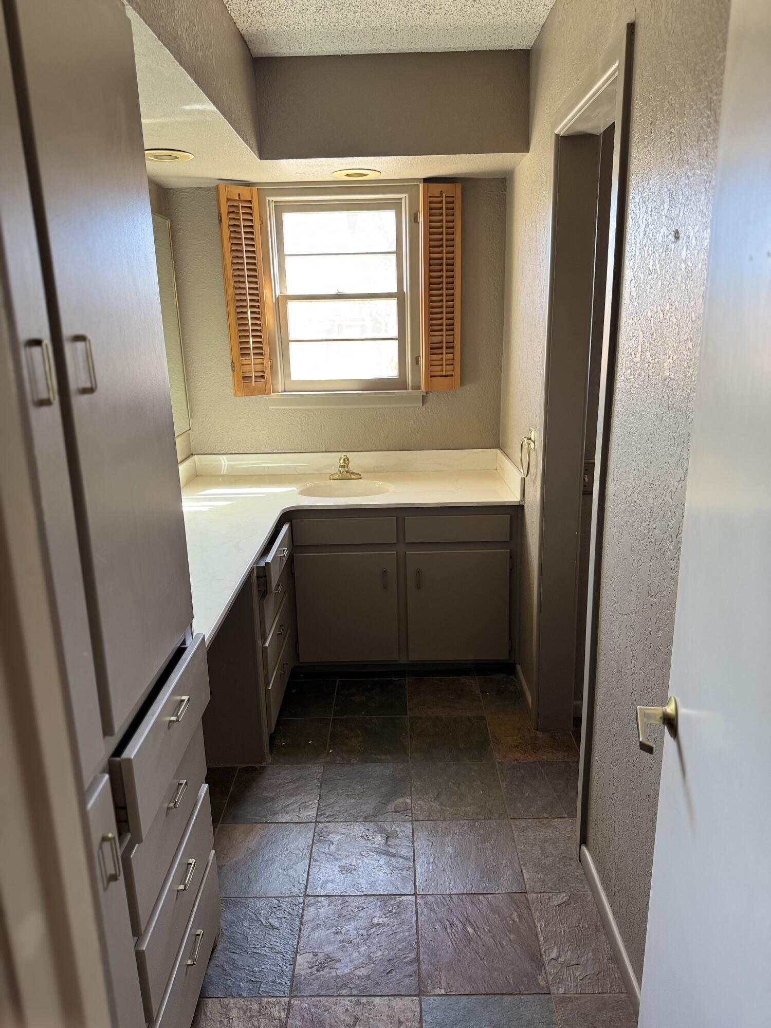 2115 62nd Street Lubbock, TX 79412 - Photo 7 of 15 a bathroom with a bathtub sink and mirror