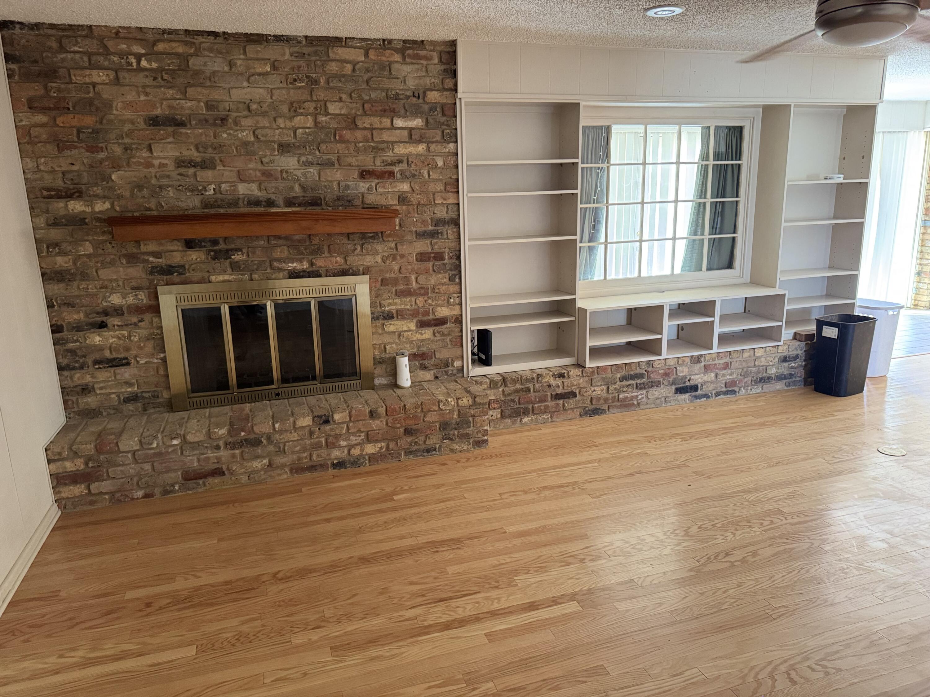 2115 62nd Street Lubbock, TX 79412 - Photo 10 of 15 an empty room with wooden floor and windows