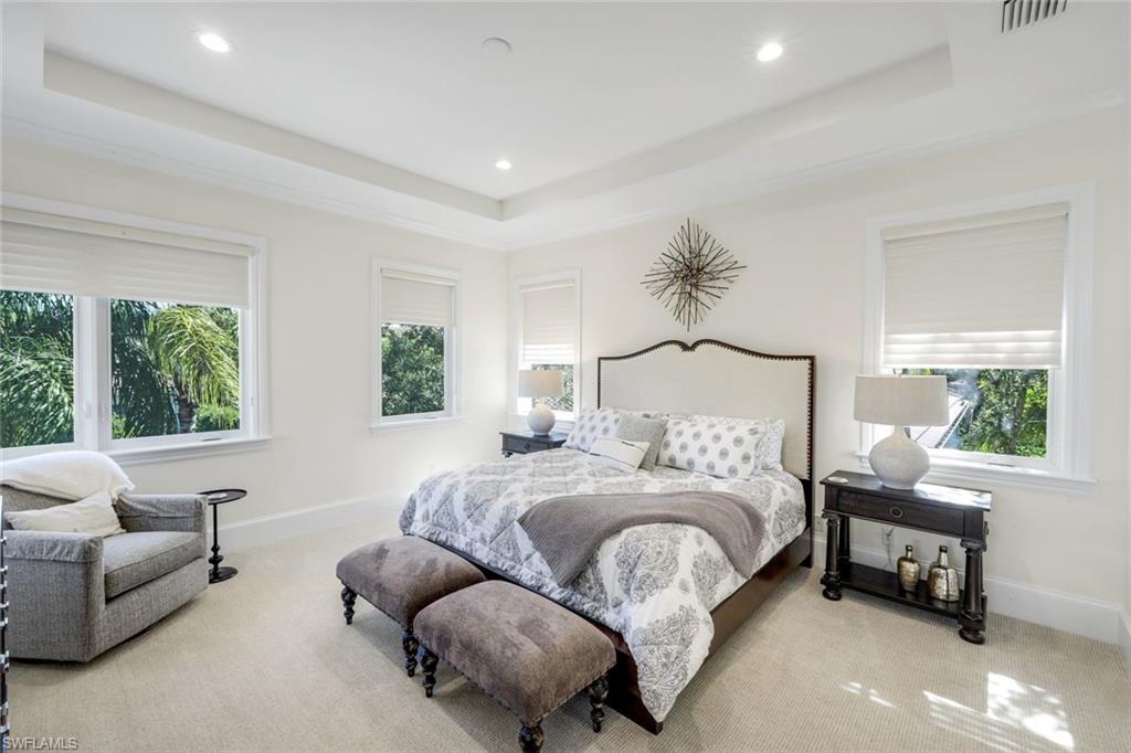 2106 Modena Court Naples, FL 34105 - Photo 25 of 42 a bedroom with a bed and a couch
