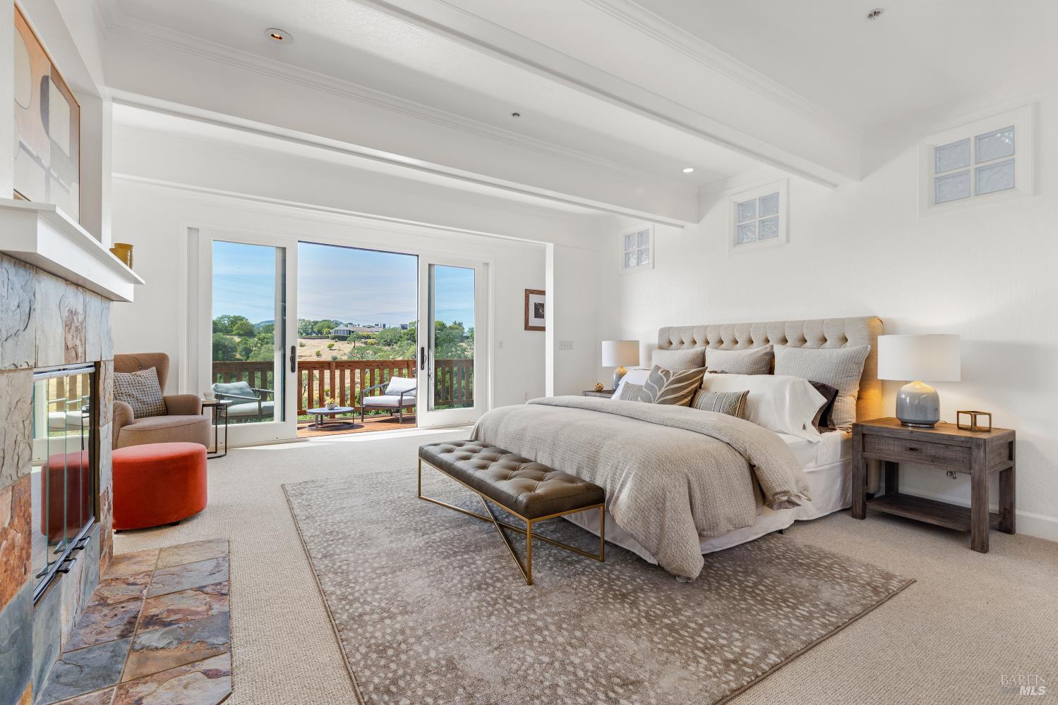 10 Lockton Lane Novato, CA 94945 - Photo 26 of 68 Grand primary suite with private deck access, wood-burning fireplace, generous scale, and a quiet retreat-like feel.