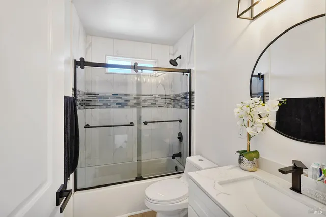 a bathroom with a sink toilet and shower