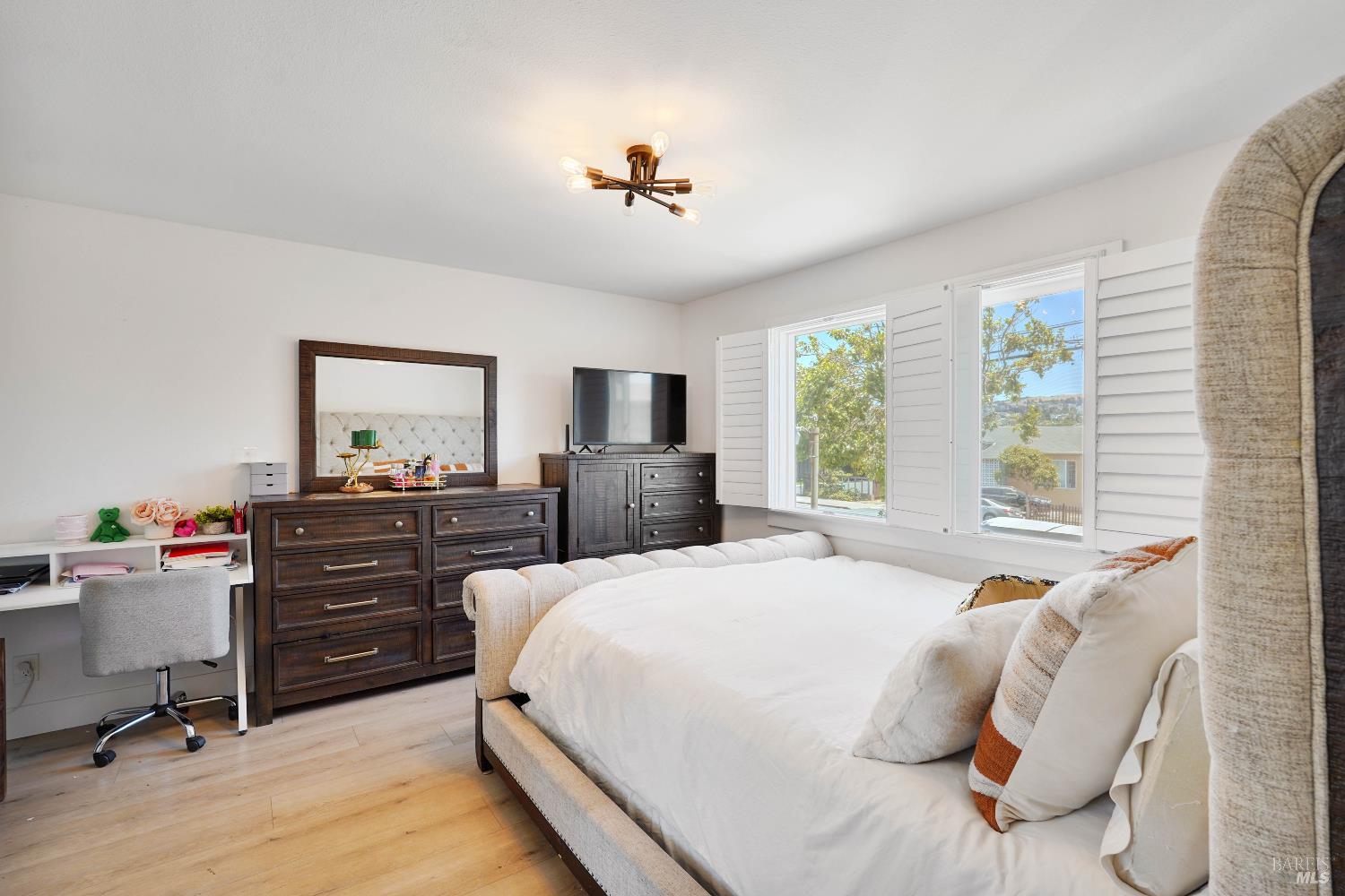 451 37th Street Richmond, CA 94805 - Photo 27 of 36 a bedroom with a bed and a chandelier