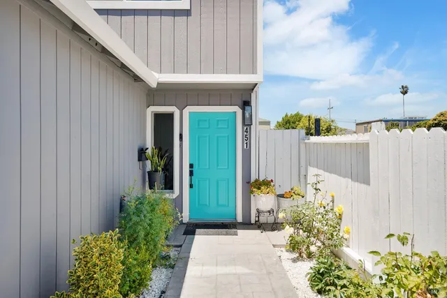 front view of a house with potted plants