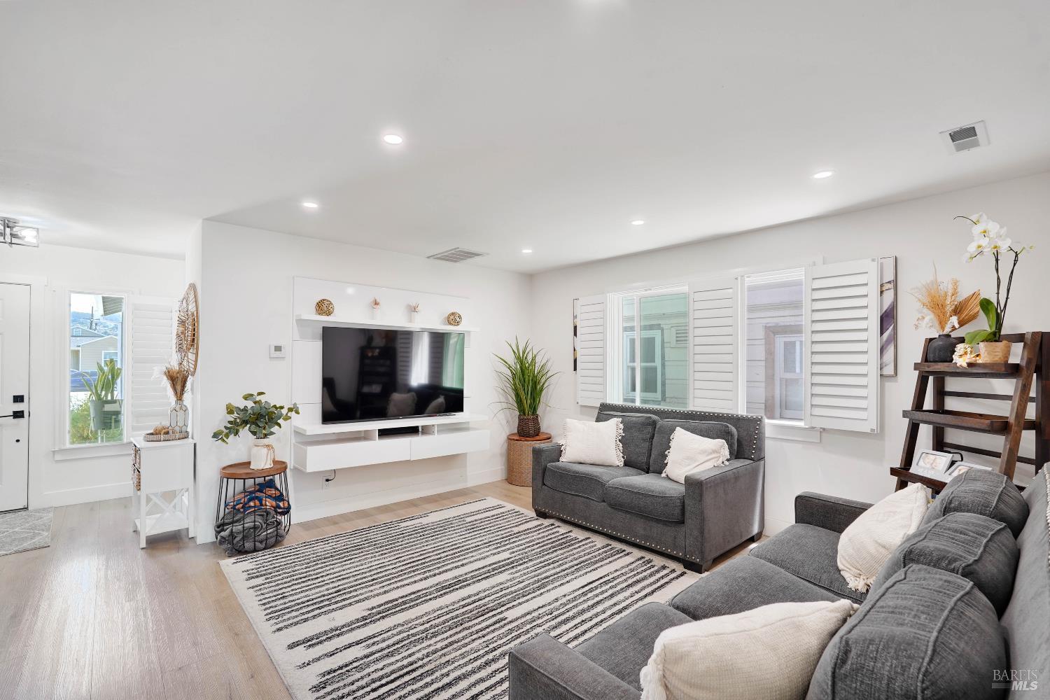 451 37th Street Richmond, CA 94805 - Photo 7 of 36 a living room with furniture and a flat screen tv