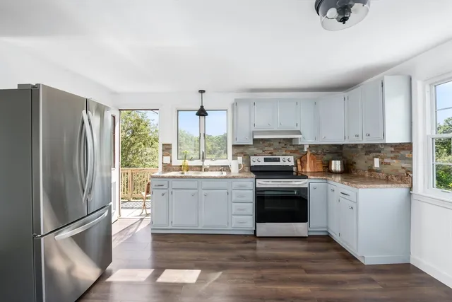a bathroom with a sink toilet a mirror and tub